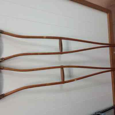 Two wood and leather crutches