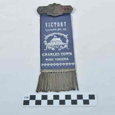 Two-sided ribbon with tin nameplate at top