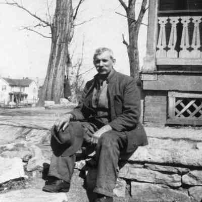 Man sitting on stone wall