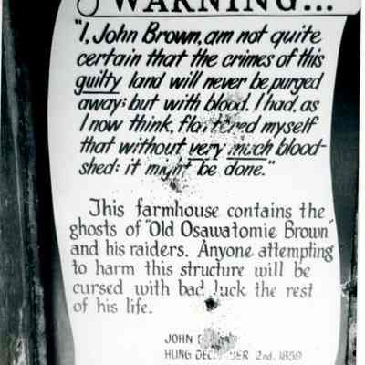 Sign that reads: "Warning...This farmhouse contains the ghosts of 'Old Osaw
