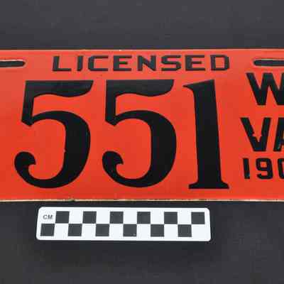 Red enameled license plate