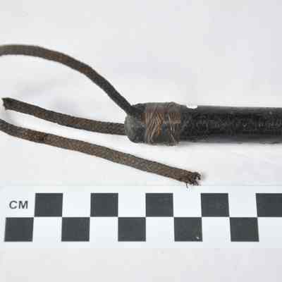 Tapered riding crop wrapped with a dark fabric
