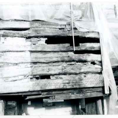 Close-up of exterior exposed wood of farmhouse with tarps