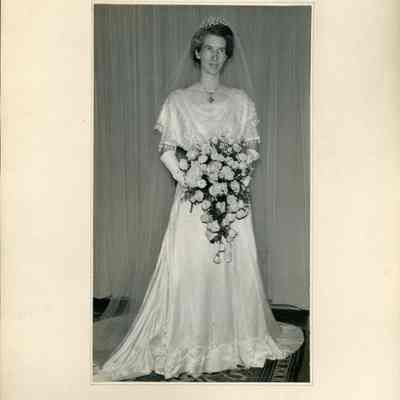 Wedding Photo - 2021.12.295b: The photograph depicts Dorothy Burnham in an elegant bridal gown holding a large bouquet.