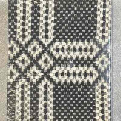 Coverlets: A Handbook on the Collection of Woven Coverlets - Back Cover: The cover of the book is made of a sample of black and white woven coverlet.