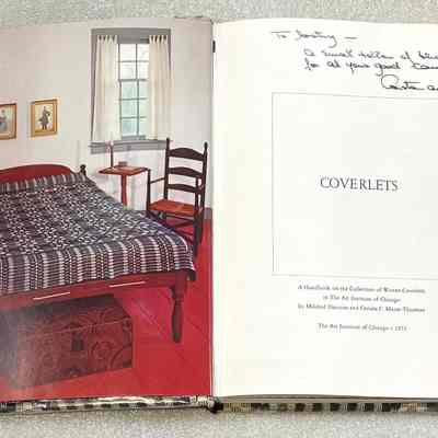 Coverlets: A Handbook on the Collection of Woven Coverlets - Inside Title Page: Open book showing a photo of a bedroom set on the left page and a title page with the word "COVERLETS" and some handwritten text on the right page.