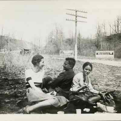 Black and White Photograph of Three People having a Picnic