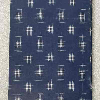 Japanese Country Textiles - Back Cover: Back cover of a book with a blue background and white grid pattern.