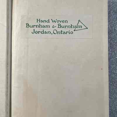 Hand-Loom Weaving - First Inside Page: The image shows the front page of a booklet labeled "Hand Woven Burnham & Burnham Jordan, Ontario," featuring a simple green triangle logo.
