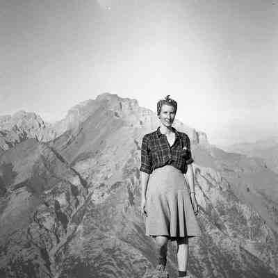 2021.12.310k: Dorothy standing at Sunshine Valley - The Simpson Pass with hills in the background. Printed version of photo is 2021.12.291g