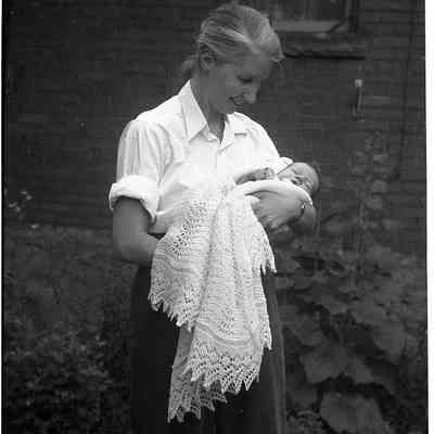 2021.12.310o: Photo of Dorothy Burnham holding a baby. Photo taken circa 1955.