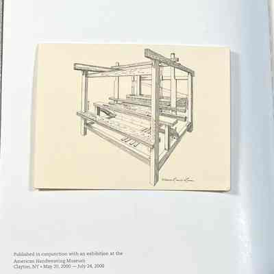Note Attached to American Handweaving Museum: Introduction to the Collection: Sketch of a wooden handloom on an open book with text about an exhibition at the American Handweaving Museum.