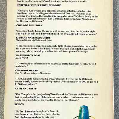 The Complete Encyclopedia of Needlework - Back Cover: Back cover of "The Complete Encyclopedia of Needlework" with several review excerpts and an illustration of a blue thimble, needle, and thread at the bottom right.