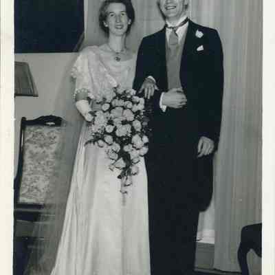 Photo - 2021.12.289b: Image of Dorothy and Harold Burnham in their wedding attire. Written on the back: "In our drawing room - notice the ring -"