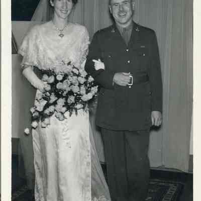 Photo - 2021.12.289g: Dorothy Burnham in her wedding dress, posing with a man in uniform (unidentified).
