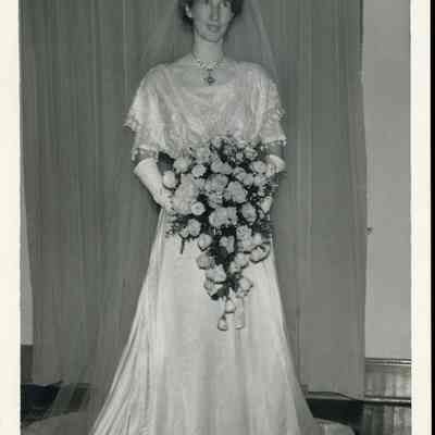 Photo - 2021.12.289i: Dorothy Burnham in her wedding dress, holding her bouquet.