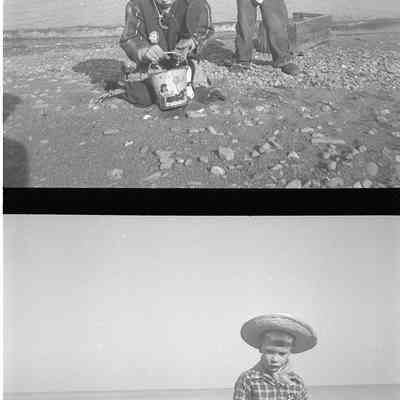 2021.12.309e: The image presents two distinct scenes split vertically. Both images capture two boys, Mark and James Burnham, playing by water on a beach while wearing cowboy attire. The bottom photo shows their dog running in front of the camera, as the photo is being taken.