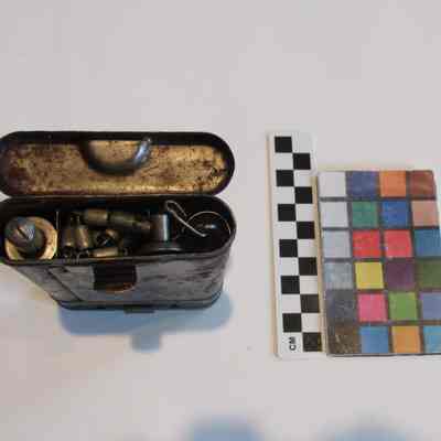 Inside bottom of cleaning kit with arrangement of tools