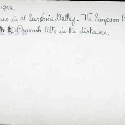 Photograph of Dorothy - 2021.12.291a (back view): The image displays a handwritten note dated August 1942, that reads "Taken in at Sunshine Valley - The Simpson Pass with the Pharaoh hills in the distance"
