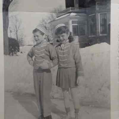 Black and white photo of Marion and Donny Sneddon on skates, 1947