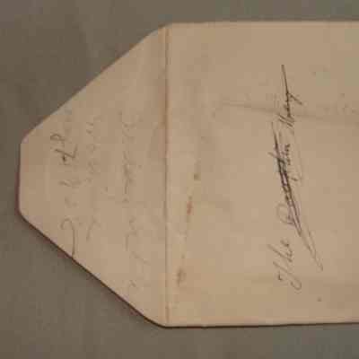 Envelope containing an orange piece of paper.