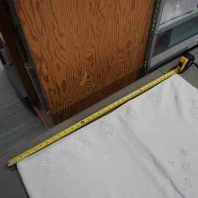 The bedspread, folded, with a measurement tape for refrence: Origsize: 91.5cmX15.5cm; Origformat: Artifact
