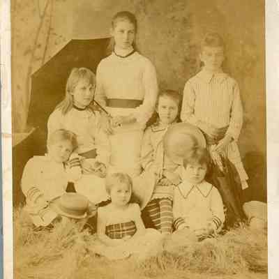 Photo of Dennistoun Girls - 2021.12.290b: Names of children written on the back. (L to R) Back row: Etta, Maggie; Second row: Mamie, Annie; Front row: Helen, Louie, Jessie.