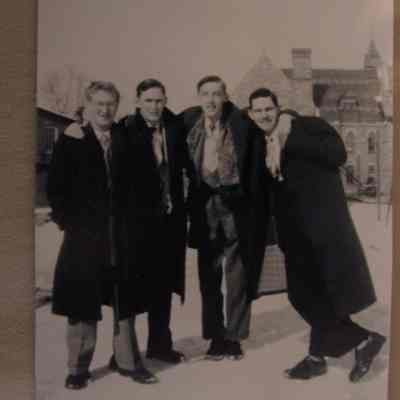 black and white photo- four men