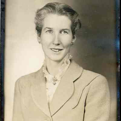2021.12.298b: The image shows a smiling Dorothy Burnham with neatly styled hair, wearing a light-colored jacket and a decorative collar.