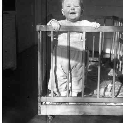 2021.12.311c: A toddler standing in his crib.