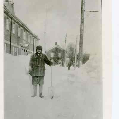 Photo of Constable and Hall Cartaker John Garrod clearing snowy sidewalks