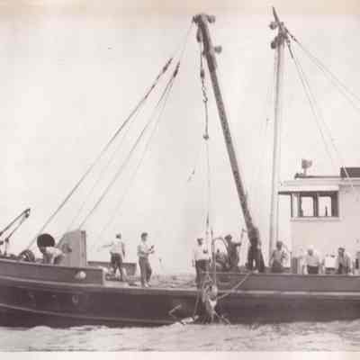 U. S. Gov't. Lighthouse Tug raising wrecked plane after being located by Game Protectors. July 30, 1936.