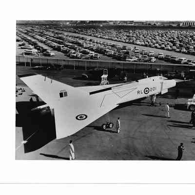 Back and White photo of Arrow RL-201 on the Ground, with staff parking in the background