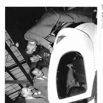 Photo of 4 Test Pilots looking into Cockpit of Arrow