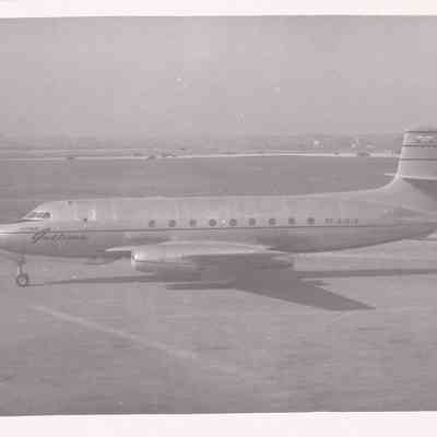 Photograph of Jetliner on tarmac, full side view.
