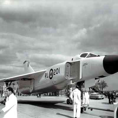 Image of the right side of the Avro Arrow on the ground with parking lot in the background