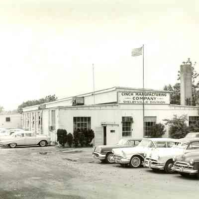Cinch Manufacturing Company, exterior view, with automobiles in the parking lot