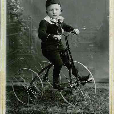 Unidentified boy on tricycle