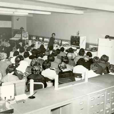 Assembly of seated women, sponsored by Indiana Gas & Water Co.