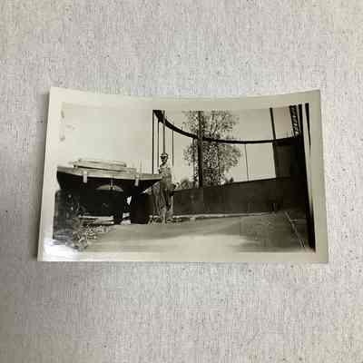 Unidentified workman standing by equipment