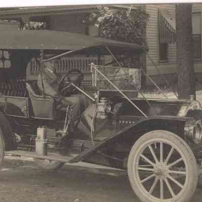 Actual Photo Post Card of a man sitting in an old car