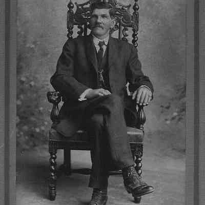 man in carved chair.