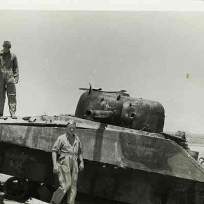Two Men with a Broken Down Tank
