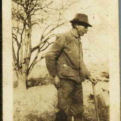 Unidentified Man Walking with a Cane