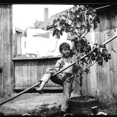  young boy; he is wearing bib overall