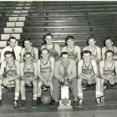 Basketball players in their uniforms with two coaches