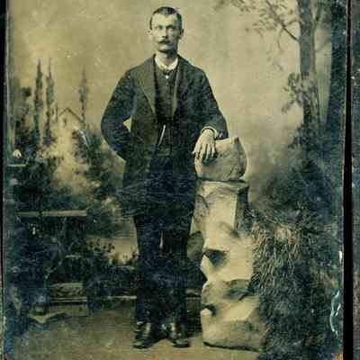 Unidentified Man Tintype Standing Beside an Artificial Rock Formation