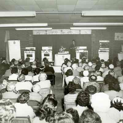 Assembly of seated women, sponsored by Indiana Gas & Water Co.