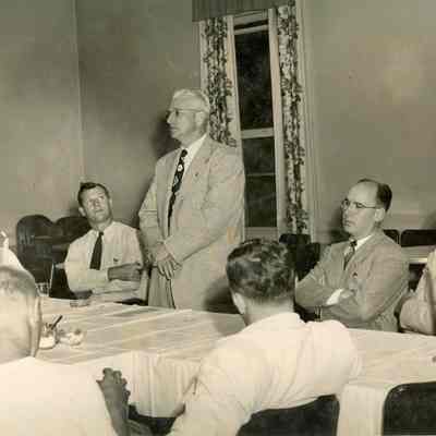 Group of seven business men, unidentified
