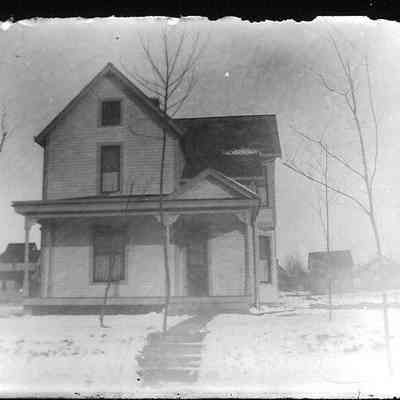 2 story house with a small attic window